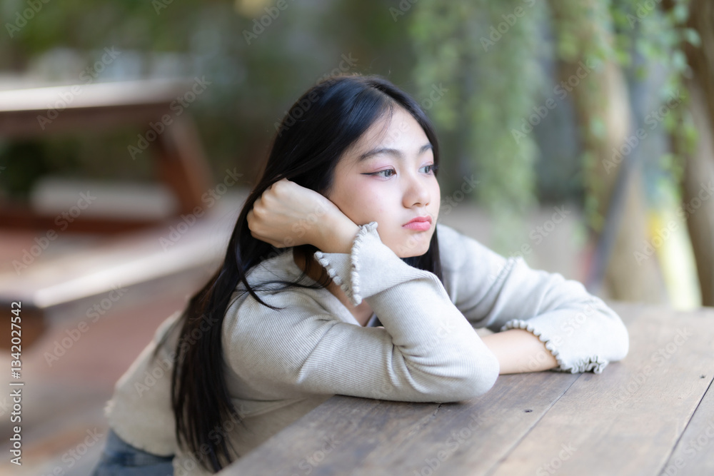 Portrait cute smiles Asian girl putting her hands on table of attractive young teenage girl the cafe on vacation at a coffee shop in spring day