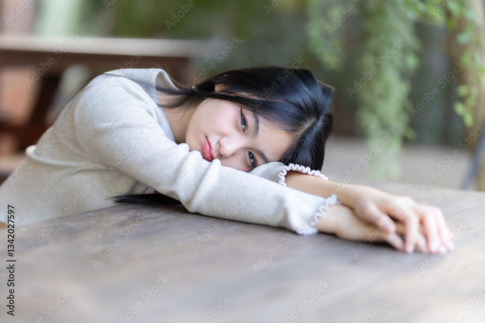 Portrait cute smiles Asian girl putting her hands on table of attractive young teenage girl the cafe on vacation at a coffee shop in spring day