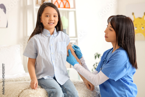 Little Asian girl disinfect...