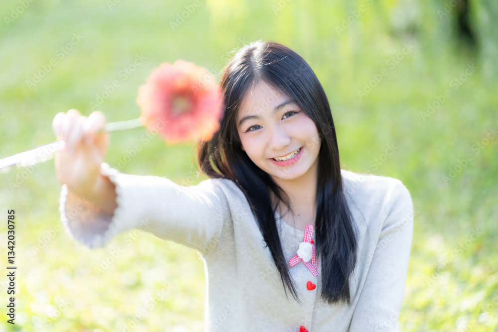Portrait cute smiles Asian of attractive young teenage girl Holding flowers the cafe on vacation at a coffee shop in spring day