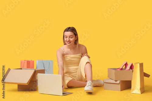 Young woman with laptop sho...