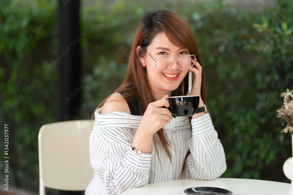 Portrait of beautiful happy Smiling asian woman relaxing and and smartphone sitting in cafe interior in coffee shop background