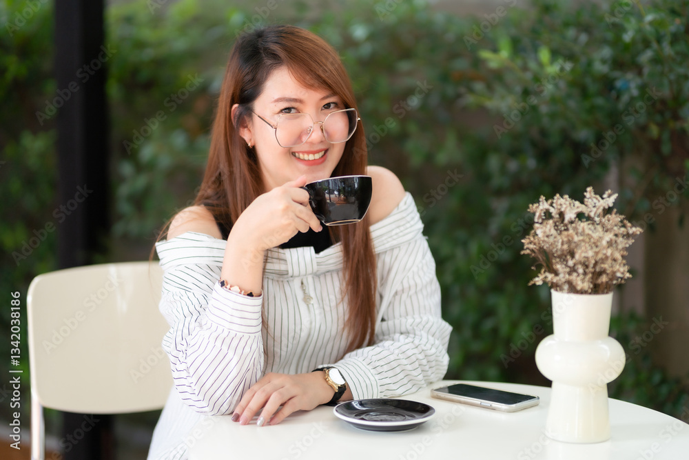 Portrait of beautiful happy Smiling asian woman relaxing and and smartphone sitting in cafe interior in coffee shop background