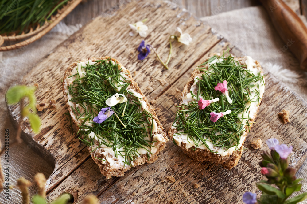 Two slices of bread with crow garlic or onion grass - wild edible plant harvested in early spring Two slices of bread with crow garlic or onion grass - wild edible plant harvested in early spring