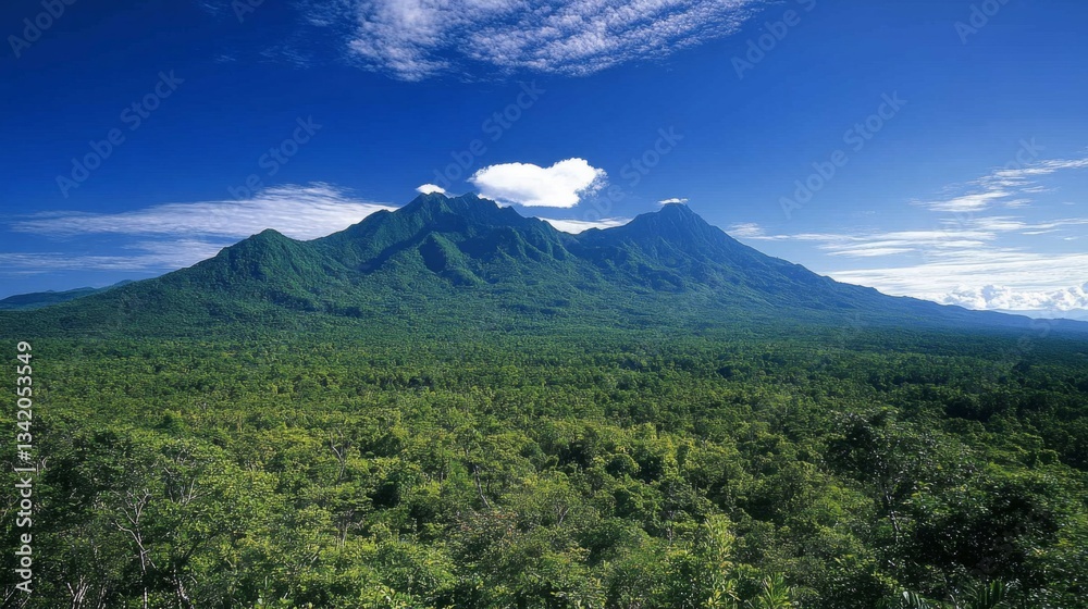 Naklejka premium Lush Green Tropical Mountain Landscape Under Blue Sky