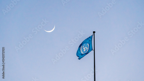 United Nations flag waving under a crescent moon