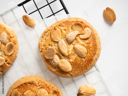Flat lay of an almond cookie on a cooling tray with a white background