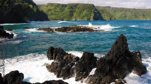 Waves Washing Against The Jagged Lava Spires in Nua' Ailua Bay, Keanae, Maui, Hawaii, USA photo