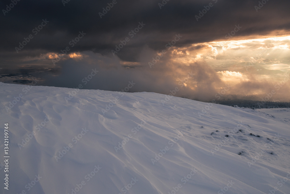 Babia Góra at sunset, covered in winter snow. A stunning mountain landscape in Babia Góra National Park, Poland. Golden light contrasts with icy peaks, creating a breathtaking view for nature and trav