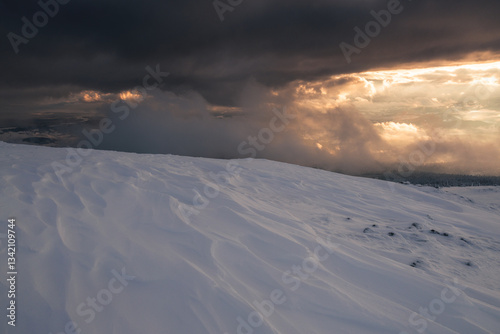 Obraz na płótnie Babia Góra at sunset, covered in winter snow. A stunning mountain landscape in Babia Góra National Park, Poland. Golden light contrasts with icy peaks, creating a breathtaking view for nature and trav w salonie