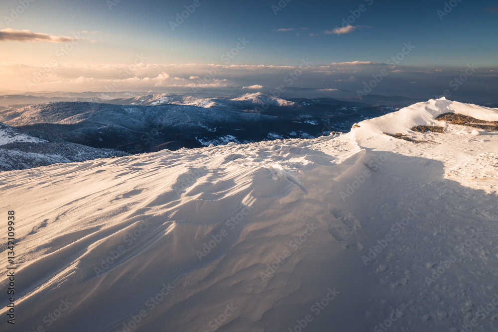 Babia Góra at sunset, covered in winter snow. A stunning mountain landscape in Babia Góra National Park, Poland. Golden light contrasts with icy peaks, creating a breathtaking view for nature and trav