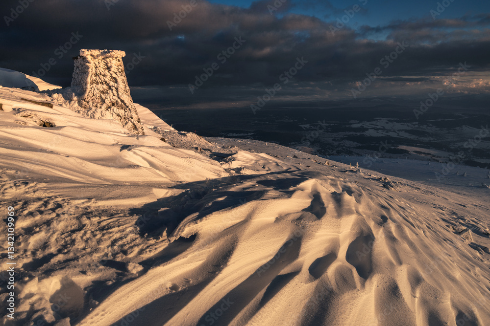 Babia Góra at sunset, covered in winter snow. A stunning mountain landscape in Babia Góra National Park, Poland. Golden light contrasts with icy peaks, creating a breathtaking view for nature and trav