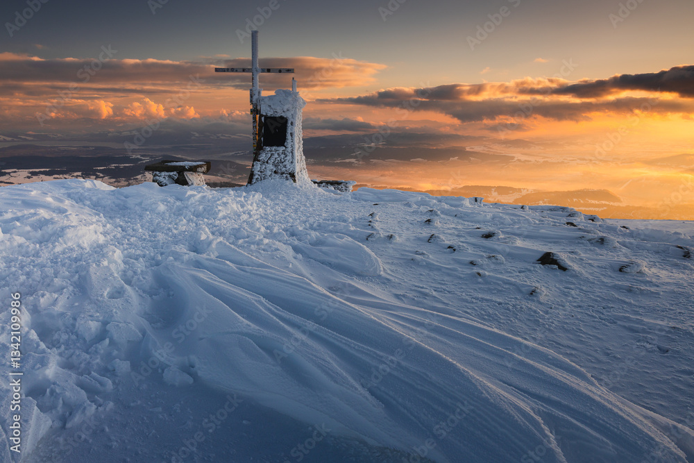 Babia Góra at sunset, covered in winter snow. A stunning mountain landscape in Babia Góra National Park, Poland. Golden light contrasts with icy peaks, creating a breathtaking view for nature and trav