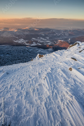 Obraz na płótnie Babia Góra at sunset, covered in winter snow. A stunning mountain landscape in Babia Góra National Park, Poland. Golden light contrasts with icy peaks, creating a breathtaking view for nature and trav w salonie