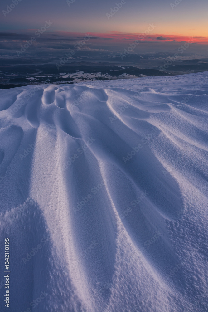 Babia Góra at sunset, covered in winter snow. A stunning mountain landscape in Babia Góra National Park, Poland. Golden light contrasts with icy peaks, creating a breathtaking view for nature and trav