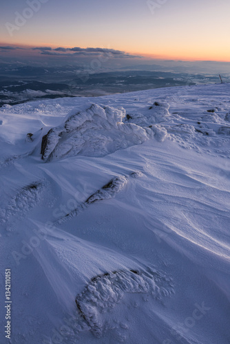 Obraz na płótnie Babia Góra at sunset, covered in winter snow. A stunning mountain landscape in Babia Góra National Park, Poland. Golden light contrasts with icy peaks, creating a breathtaking view for nature and trav w salonie