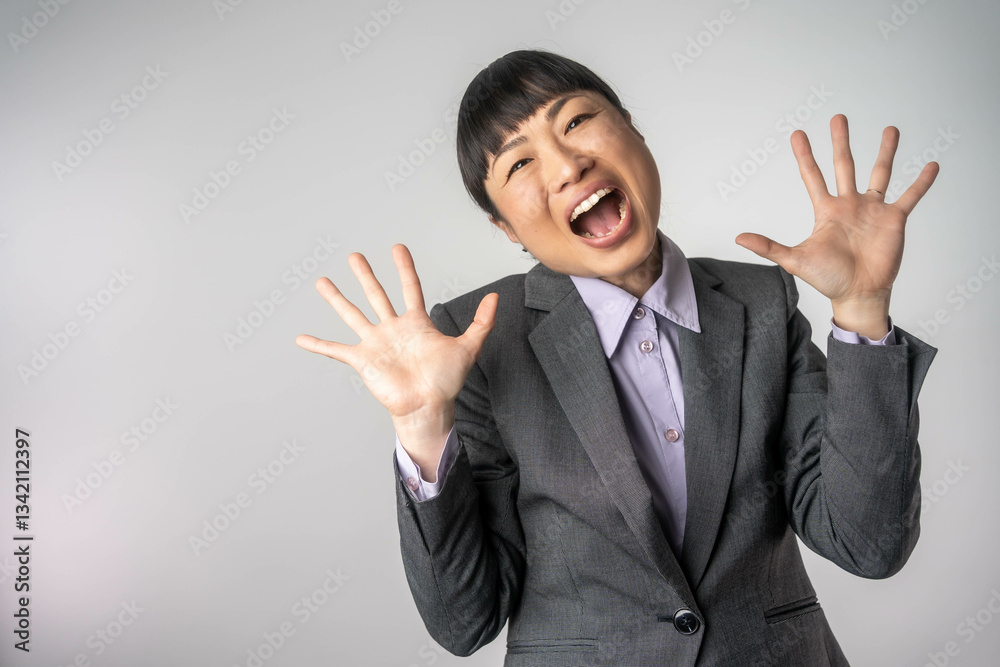 Wow. Beautiful female businesswoman front portrait isolated on gray studio backgroud. Confident emotional surprised asian woman standing with open mouth. Human emotions, facial expression concept Wow. Beautiful female businesswoman front portrait isolated on gray studio backgroud. Confident emotional surprised asian woman standing with open mouth. Human emotions, facial expression concept
