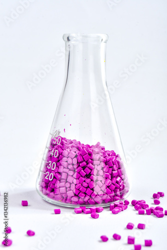 Purple masterbatch granules in Erlenmeyer flask isolated on white background, color pigment carrier polymer in plastic industry. Perfect for plastic company catalog design