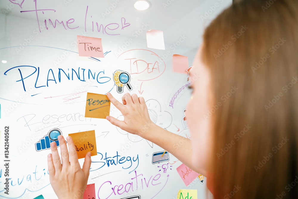 Closeup of professional businesswoman hand put and stick the colorful sticky notes on whiteboard while presenting business plan. Creative business meeting and brainstorming concept. Immaculate. Closeup of professional businesswoman hand put and stick the colorful sticky notes on whiteboard while presenting business plan. Creative business meeting and brainstorming concept. Immaculate.