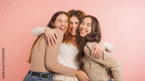 Fotografi Three joyful friends embracing with laughter