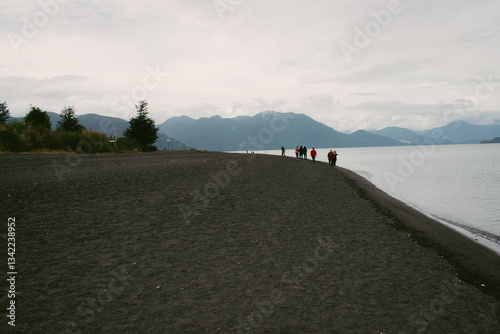 Scenic views of a lake surrounded by lush forests and rolling hills. Nature’s beauty unfolds with towering trees, serene waters, and distant mountains, creating a peaceful and pristine landscape