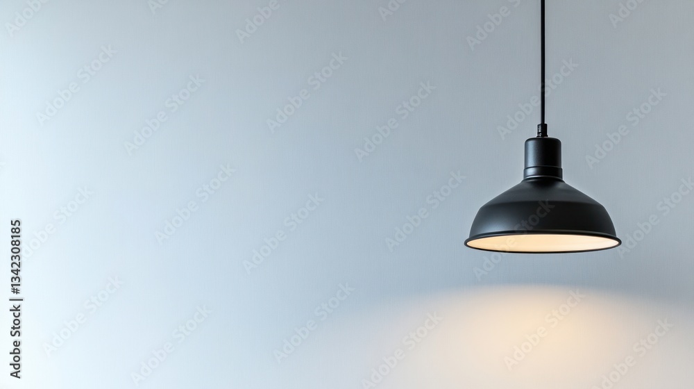 Obraz premium Minimalist Black Pendant Lamp Against a Light Blue Wall