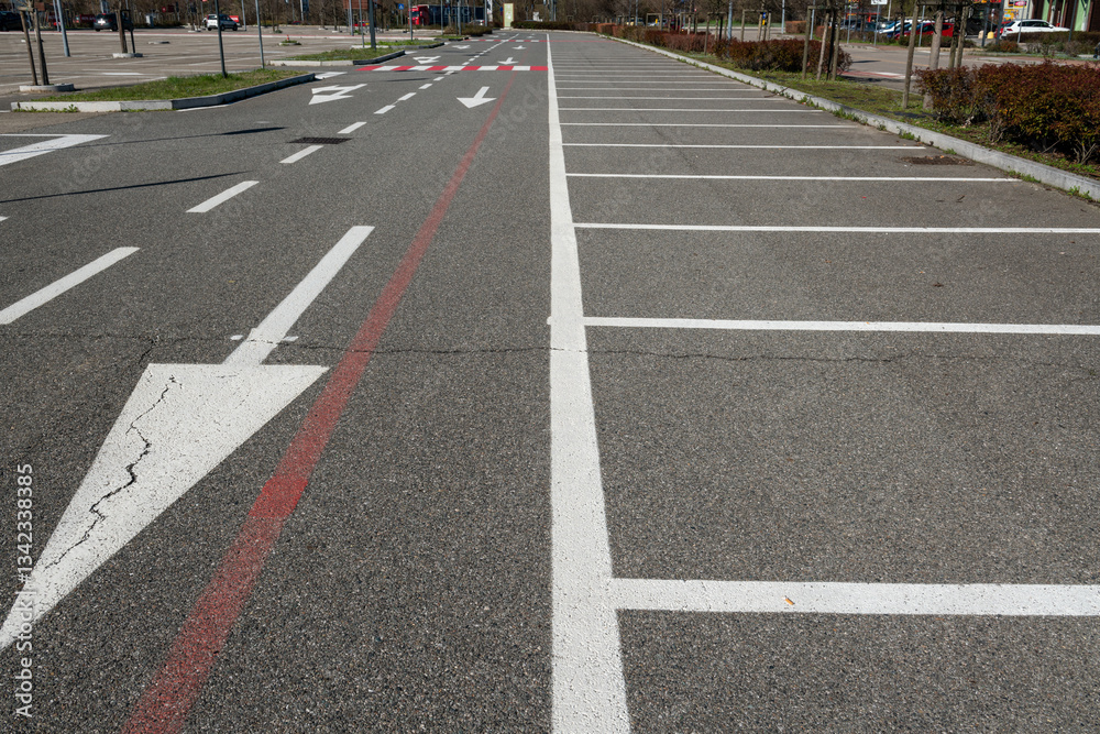 Fototapeta premium road signs with mandatory direction arrows and parking space lines. symbols on asphalt are dictated by the highway code. road design starts with the study of mobility, frequency and travel data.