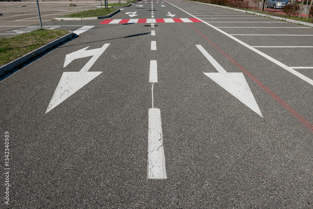 road signs with mandatory direction arrows and parking space lines. symbols on asphalt are dictated by the highway code. road design starts with the study of mobility, frequency and travel data. road signs with mandatory direction arrows and parking space lines. symbols on asphalt are dictated by the highway code. road design starts with the study of mobility, frequency and travel data.