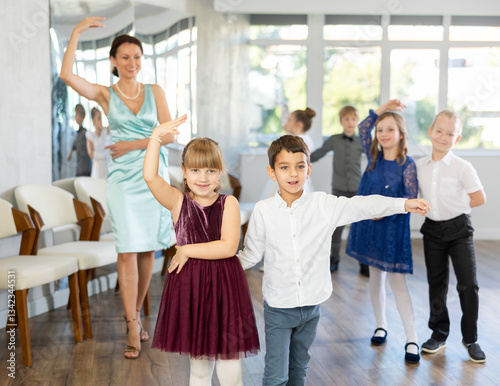 Children dance in pairs at a festive matinee