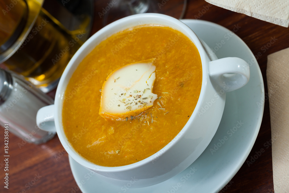 Plate of low calorie pumpkin and carrot puree served with cheese and herbs Plate of low calorie pumpkin and carrot puree served with cheese and herbs