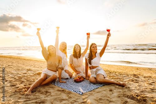 Cheers, friends and picnic on beach with wine with girls, bonding and celebration on holiday or vacation. Hen party