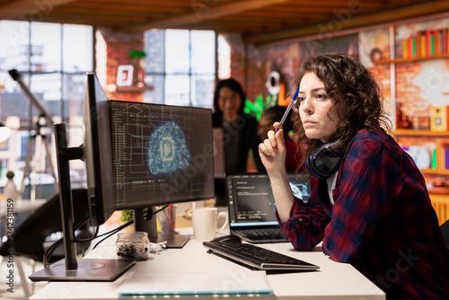 Woman working in AI tech agency providing custom software development services. IT expert using artificial intelligence technology to streamline coding process in innovative startup office