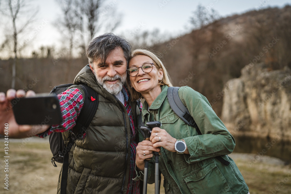 Fototapeta premium happy couple hiker backpacker explore forest and take self portrait