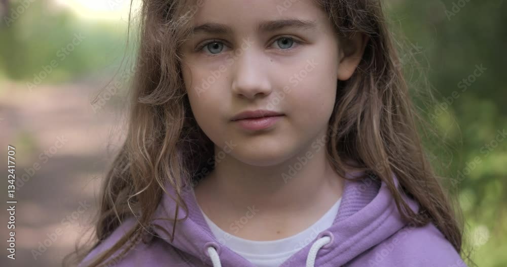 Portrait Child Girl Looking at Camera Standing on Street in City on Summer Day. Sad Thinking Curiosity Teenager Looking at Camera Closeup Outdoors. Human Face Eyes Serious Contemplative Child. Portrait Child Girl Looking at Camera Standing on Street in City on Summer Day. Sad Thinking Curiosity Teenager Looking at Camera Closeup Outdoors. Human Face Eyes Serious Contemplative Child.
