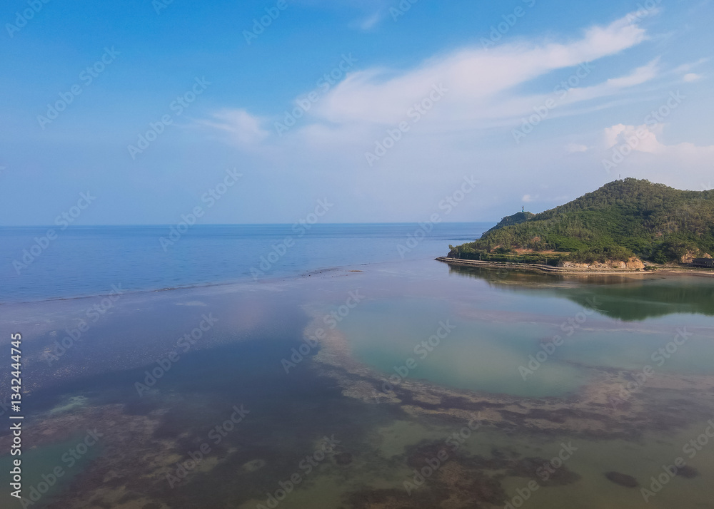 Fototapeta premium The beauty of Christo Rei Beach and Fatucama Hill seen from a height, one of the most famous tourist destinations in Dili City, Timor Leste. Aerial view.