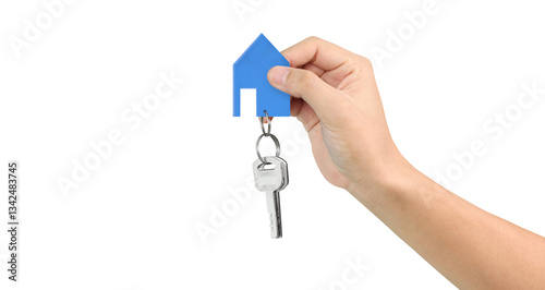 Hand holding house key and blue paper house symbolizing new home ownership indoor setting real estate concept close-up view for seo impact
