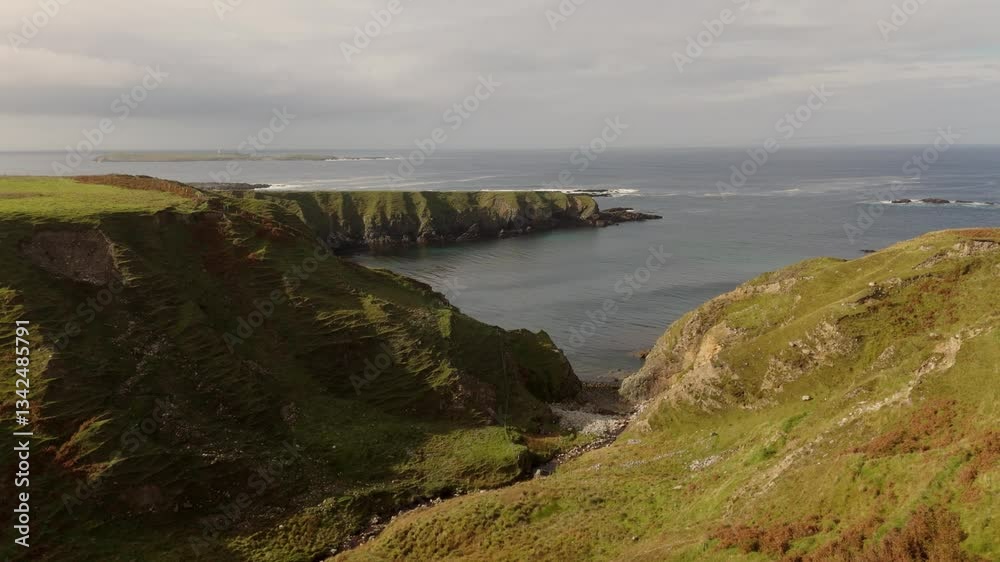 A breathtaking rocky coastline view under cloudy skies captures the tranquility of nature beautifully