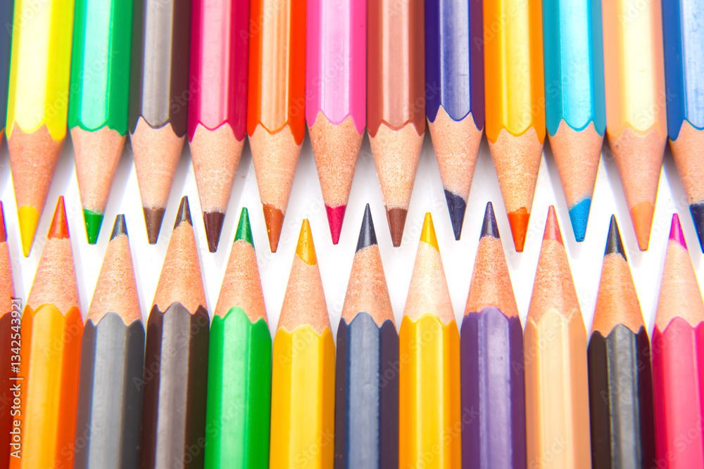 Sharpened multicolored pencils in a grid pattern. Suitable for art supplies, educational materials, or creative stationery imagery. Sharpened multicolored pencils in a grid pattern. Suitable for art supplies, educational materials, or creative stationery imagery.