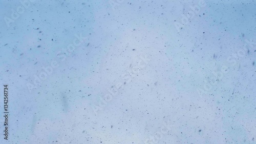 Snowflakes Falling Against Blue Sky, Close Up.
 Winter Nature Scene.