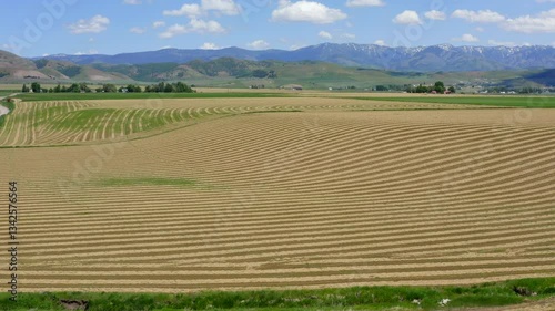 Aerial Drone Flying Above a Harvested Farm Field in a Rural Countryside