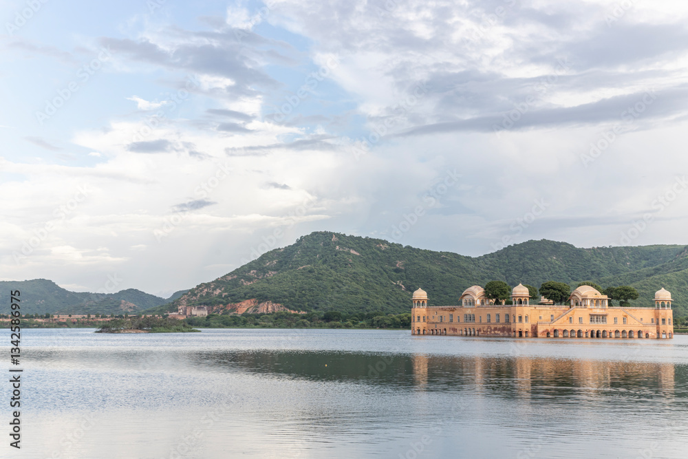 Fototapeta premium The Jal Mahal Palace, located in Man Sagar Lake, offers a stunning view at sunrise in Jaipur, Rajasthan, India.