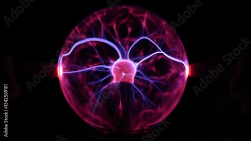 Close Up of a Plasma Globe Lamp With Fingers Touching it on Both Sides