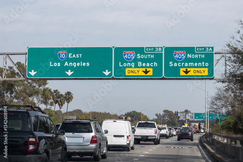 Slow traffic driving below freeway signs on the Santa Monica 10 freeway at the San Diego 405 freeway interchange in Los Angeles.  