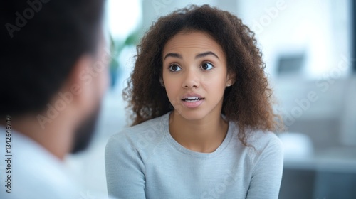 Young woman in concerned conversation, listening intently to someone