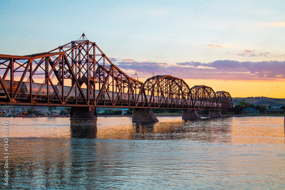 Sunset Over Historic Train Bridge in Fort Pierre, South Dakota with Train on Missouri River Sunset Over Historic Train Bridge in Fort Pierre, South Dakota with Train on Missouri River