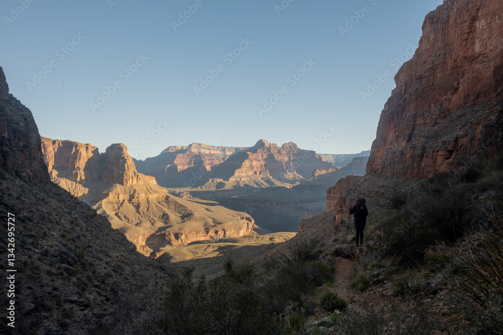 Hiker Climbs Up The Steep Trail To The Top of Whites Butte