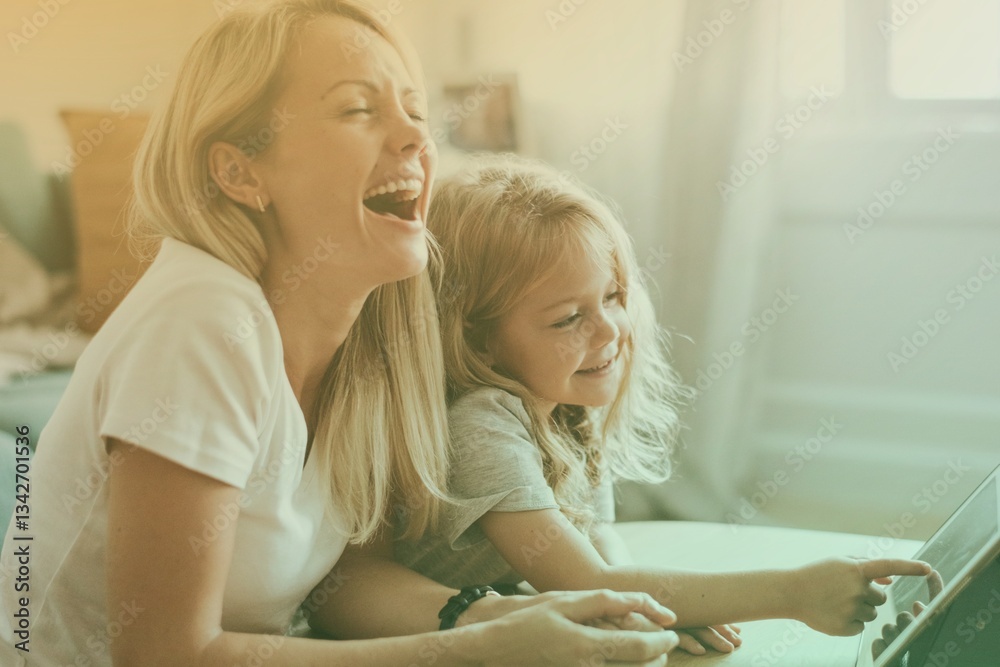 Mom and daughter watching a cartoon on a digital tablet Mom and daughter watching a cartoon on a digital tablet