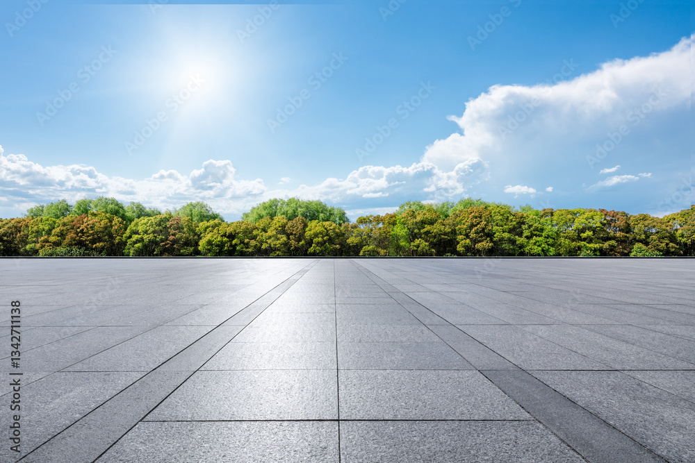 Empty square floor and green tree landscape under blue sky