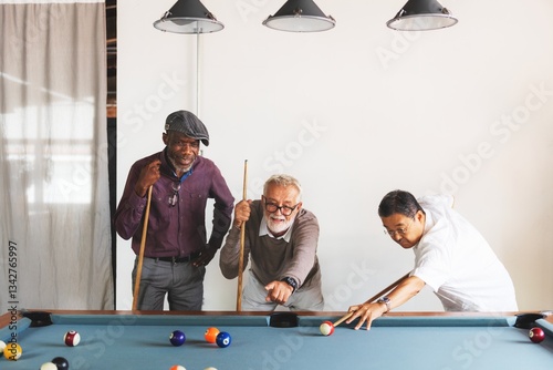 Three diverse elderly men playing pool. Diverse old men enjoying a game. Diverse group of elderly men, focused on pool. Leisure time for elderly men, sharing a game of pool. Happy diverse senior men.