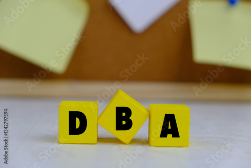 DBA. Doctor of Business Administration. text on wood cubes. text in black letters on wood blocks